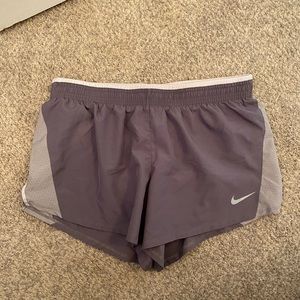 Women’s Nike Running Shorts. Color gray with white detailing. Size large.